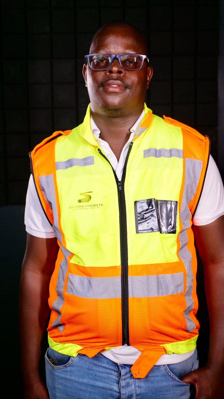 Kaymou Projects team member in branded safety gear